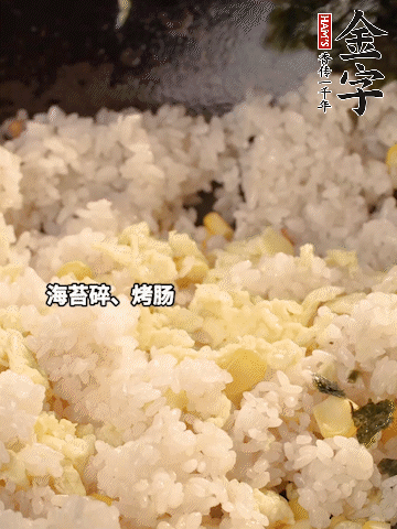 剩米飯下鍋炒散，依次下玉米粒、雞蛋、烤腸、海苔碎翻炒均勻。