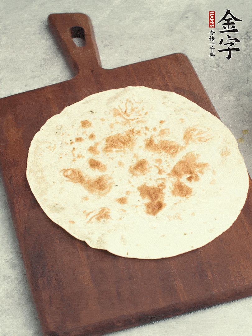 食材依次鋪在卷餅皮上，卷起來(lái)。