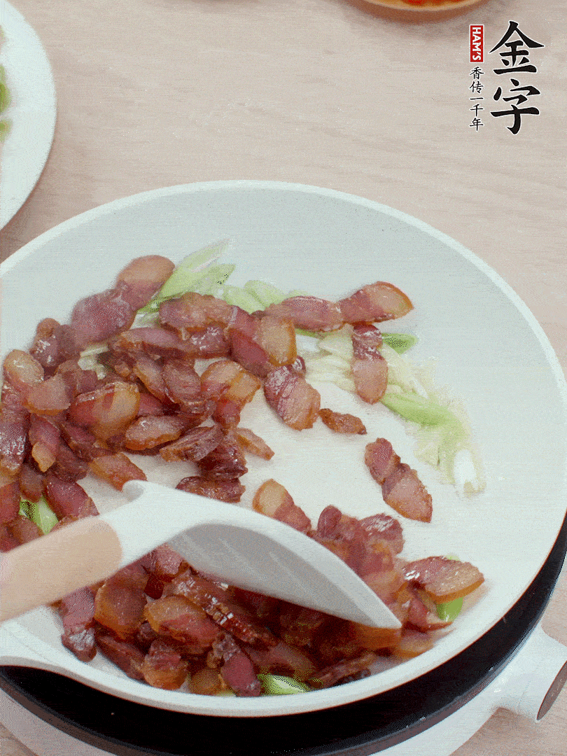 鍋中少許油，姜、蒜白爆香，下臘肉煸出油脂。