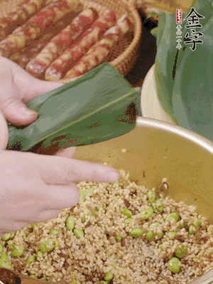 粽葉往下折，完全蓋住，兩側(cè)捏緊。
